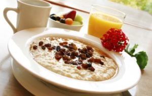 Breakfast of freshly prepared oatmeal topped with raisins. Served with your choice of coffee or orange juice and a cup of fruit.